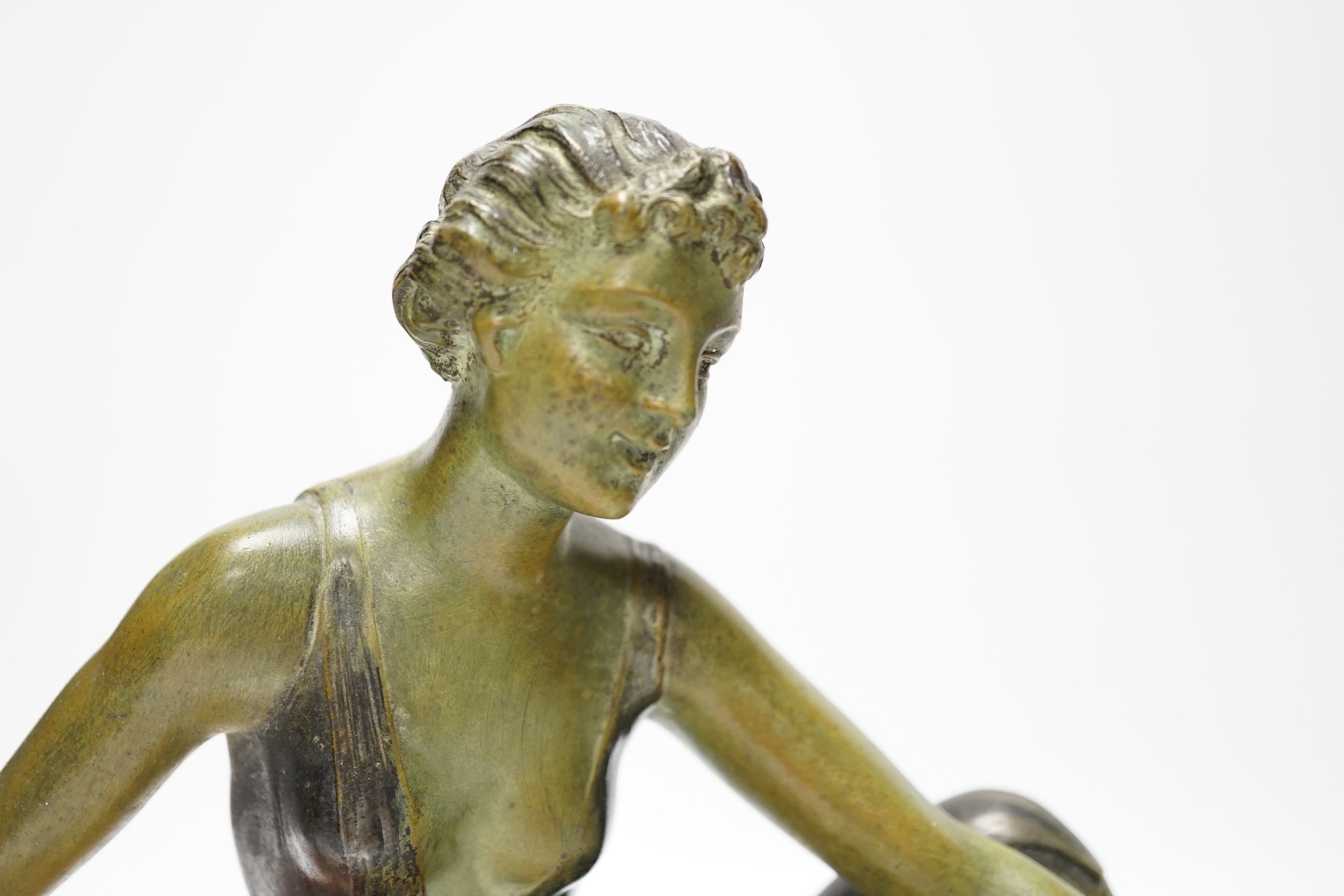 An Art Deco patinated spelter and marble figure, signed A. Leclerc, 40cm wide